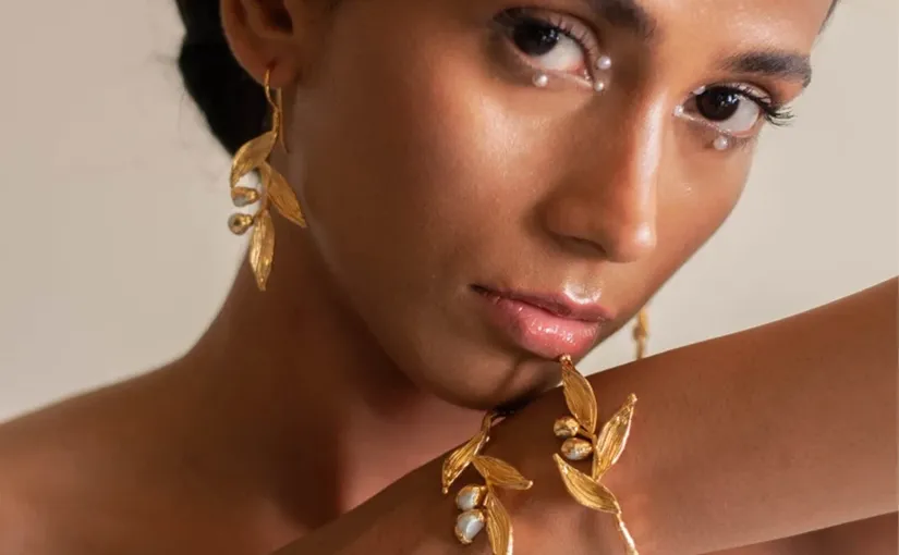 A photo of a woman modeling artisanal jewelry.