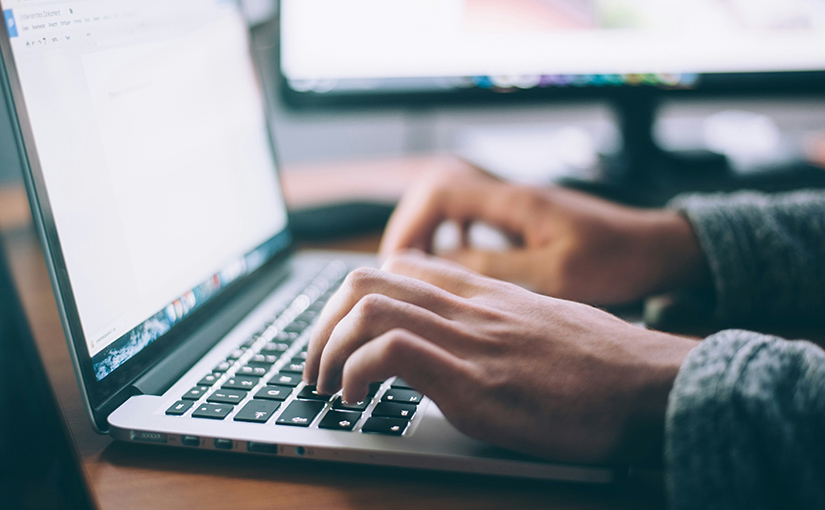 A photo of a person on a laptop, working on an e-commerce business.