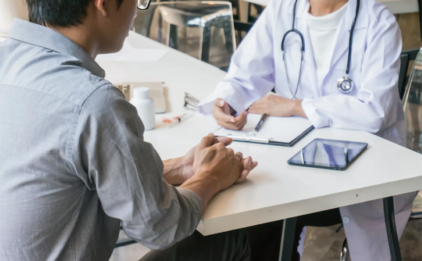 A photo of a person and a healthcare worker discussing distribution.